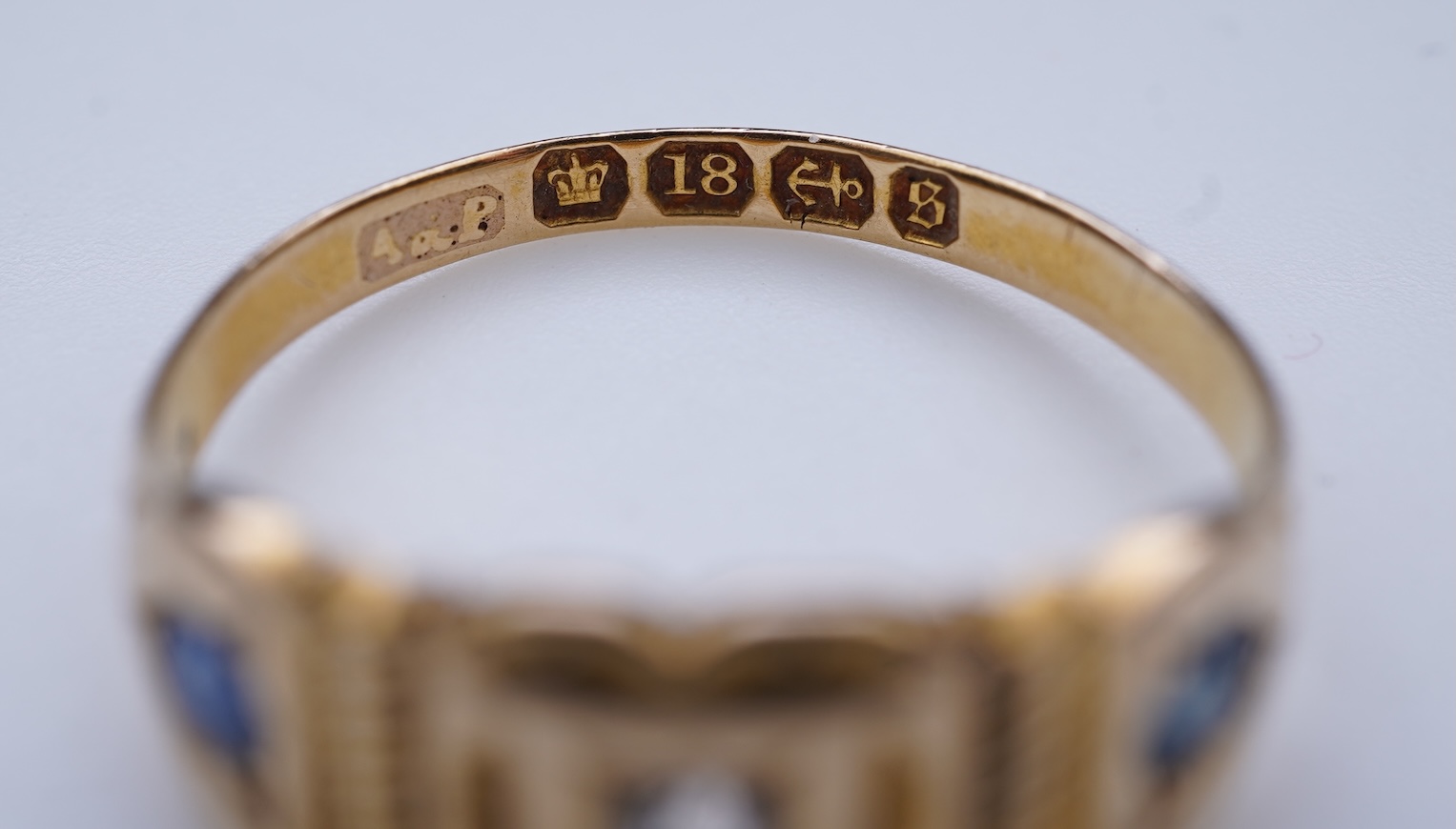 A Victorian sapphire and diamond three-stone ring, circa 1892